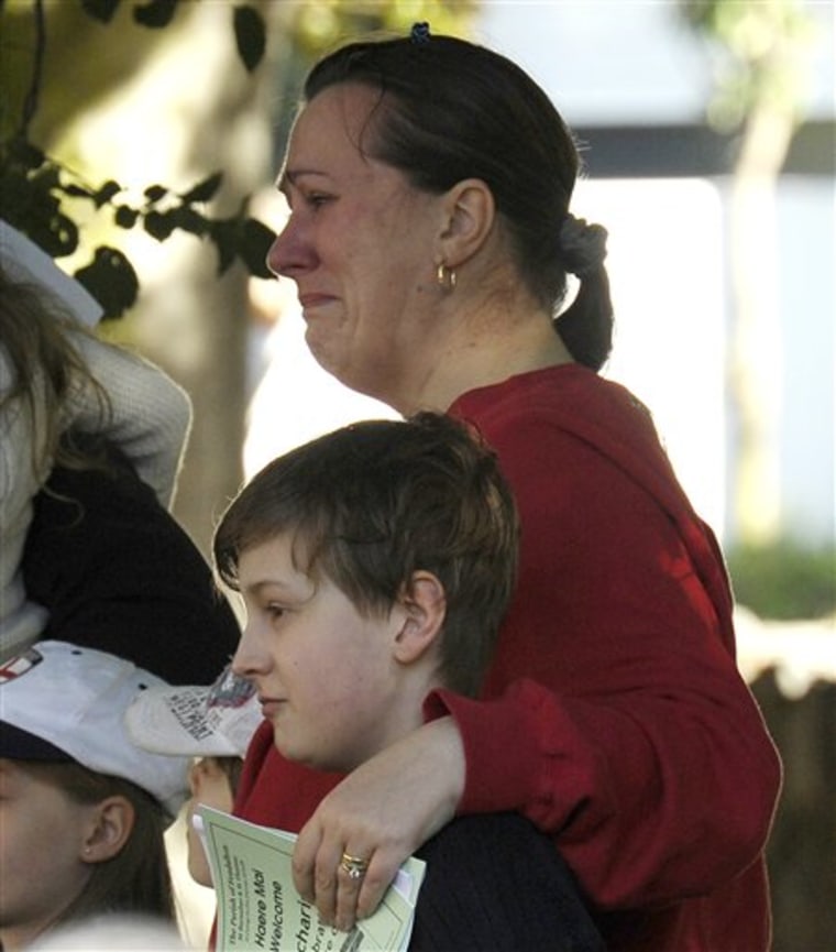 Joanne Fagan-Oslawskyj weeps as she attends a church service at St. Barnabas with her 8-year-old son old Jamie in Christchurch, New Zealand on Sunday. New Zealand's premier said Tuesday's quake may be the country's worst disaster ever, as officials raised the death toll nearly 150 and more than 200 missing. 